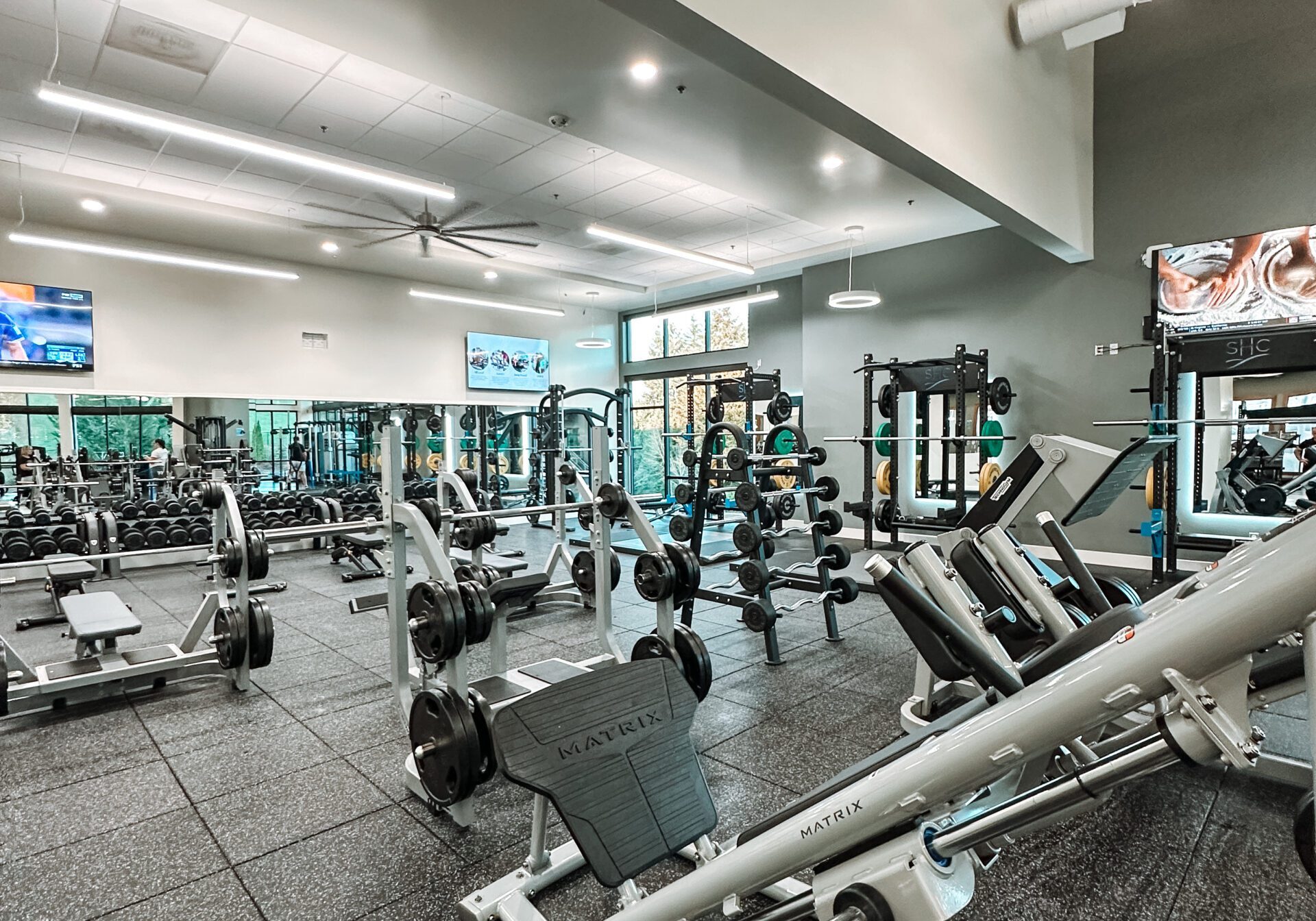 The strength training floor, with free weights and Matrix machines under high ceilings